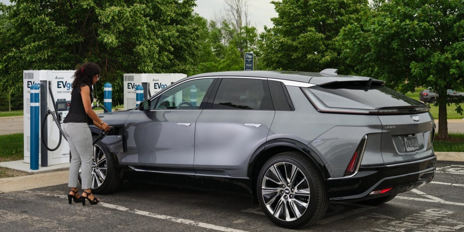 Woman charging a 2023 Cadillac LYRIQ at an EVgo charging station. (Photo by Steve Fecht for Cadillac)