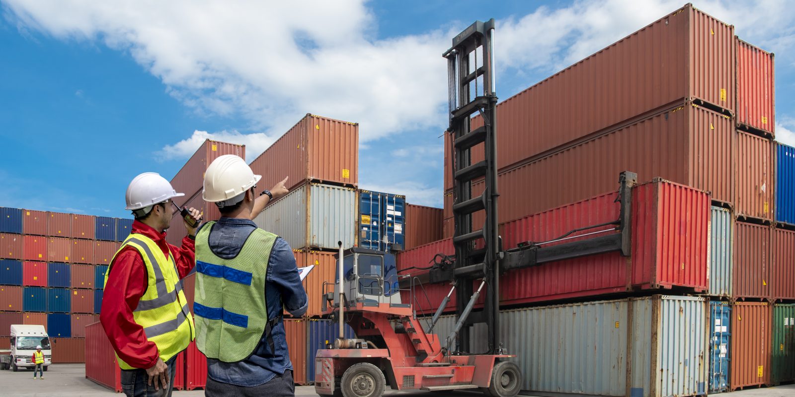 Foreman control loading Containers box to truck for Logistic Import Export Background, Business logistic concept, import and export concept.