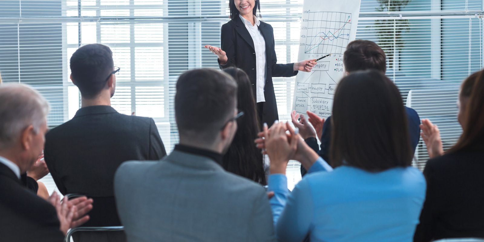 rear view. businesswoman making a presentation for the employees of the company