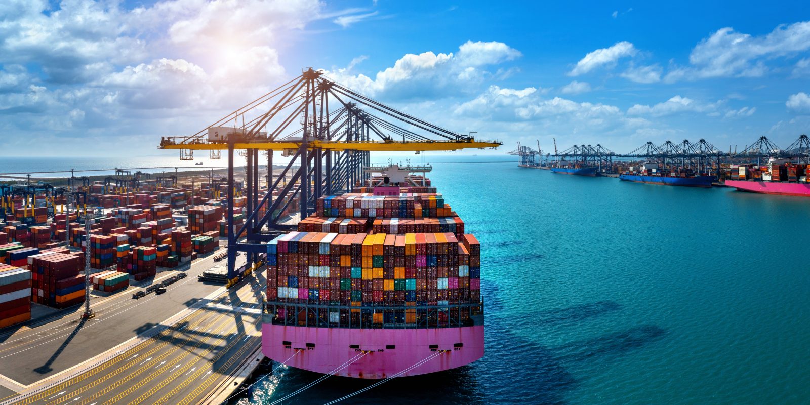 Aerial view of cargo ship and cargo container in harbor.